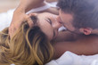 © Photographee.eu - Married couple kissing in bed