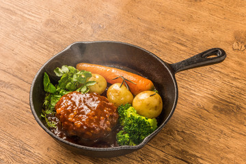 Wall Mural - スキレットと焼きたてハンバーグステーキ　 American dish hamburger steak