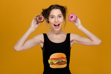 Poster - Lovely woman in black top with hamburger print holding donuts