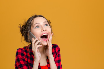 Canvas Print - Charming surprised content young woman talking on cell phone