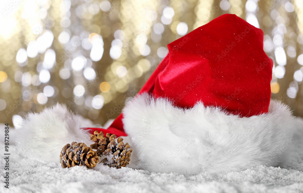 Santa Claus red hat with Christmas decorations on shiny background, close up