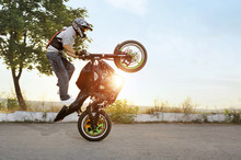 His Way To Impress. Shot Of A Stunt Rider Practicing For The Extreme Competition Outdoors On Sunset Soft Smudged Focus
