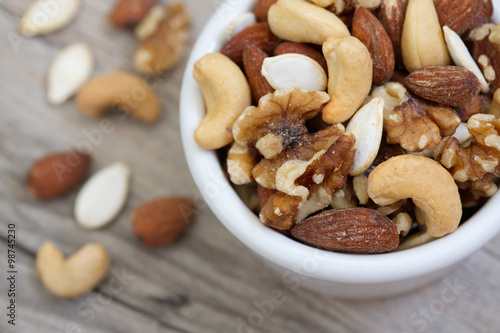 Fotografía Bowl of Mixed Nuts on Rustic Wooden Table