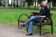 © alexkich - man reading books in the park