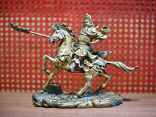 Knight On Horseback Miniature. Metallic Knight Holding A Sword On The Back Of A Horse