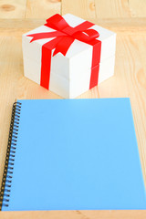 Wall Mural - Gift box with red wrapped and blank paper put on wooden table