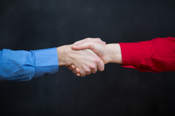 business couple shaking hands at the office