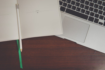 workspace with modern laptop and notebook in vintage style.
