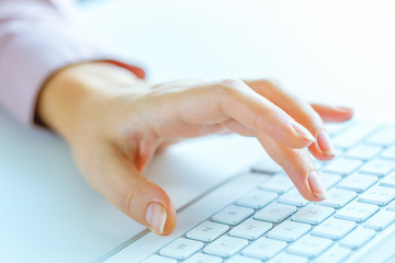 Woman office worker typing on the keyboard