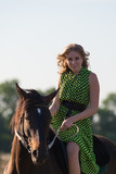 Fototapeta Konie - Young beautiful girl with a horse on nature