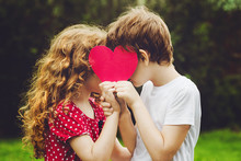 Cute Children Holding Red Heart Shape In Summer Park. Valentines