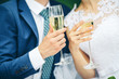 Bride and groom holding wedding champagne glasses