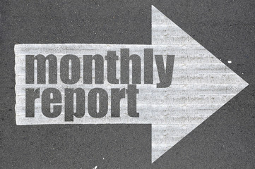 Arrow on asphalt road written word monthly report