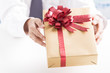 © Nonwarit - Business man offering a gift