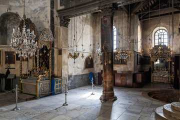 Church of the Nativity interior with icon-lamps hanging on long chains in Bethlehem.