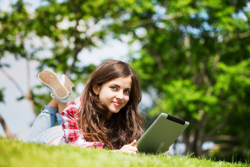 Wall Mural - beautiful young woman outdoors with touchpad.