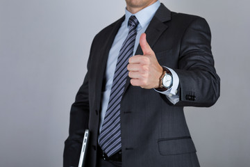 Business man showing thumbs up