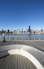 Scenic Skyline View Of Midtown Manhattan From A Wood Deck Across The East River In Queens, New York City