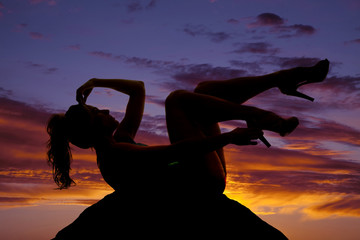 Wall Mural - silhouette of a woman laying back legs up arm over face