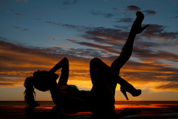 Wall Mural - silhouette of a woman laying back leg up with reflection