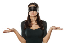 Confused Blindfolded Woman On A White Background