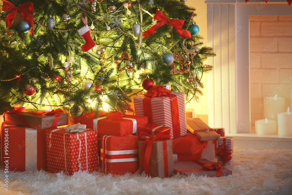 Christmas tree with presents near the fireplace