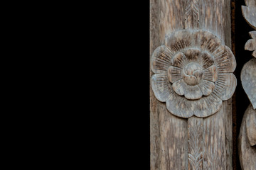 Wall Mural - Thai wood carving of flowers on a black background