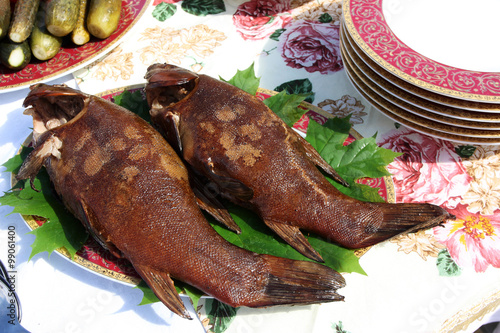 Fényképezés Freshly grilled tenches (Tinca tinca) on the plate in the open air restaurant