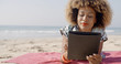 © Dash - Woman Uses A Tablet On The Beach
