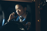 Fototapeta Kwiaty - Young asian businessman calling with cellphone in car at night.
