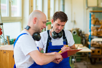 two worker in a carpenter's workshop