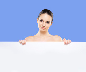 Wall Mural - Portrait of young, beautiful and healthy woman with a blank bann