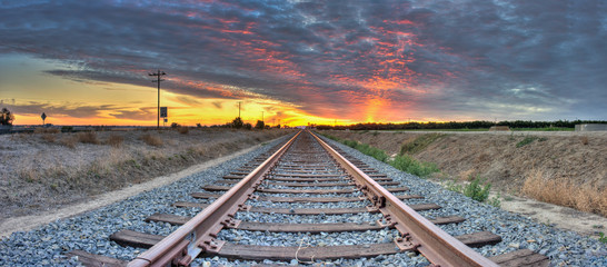 Panoramic view of railroad tracks crossing the frame from right to left. 