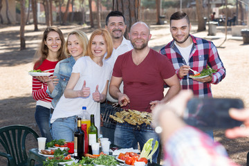 Adults doing selfie at picnic