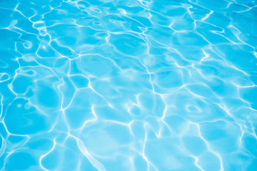 Wall Mural - Blue water rippled background in swimming pool