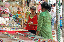 Mother And Teenage Daughter Looking For Fancy Jewelry And Accessories In A Flea Market In Goa, India