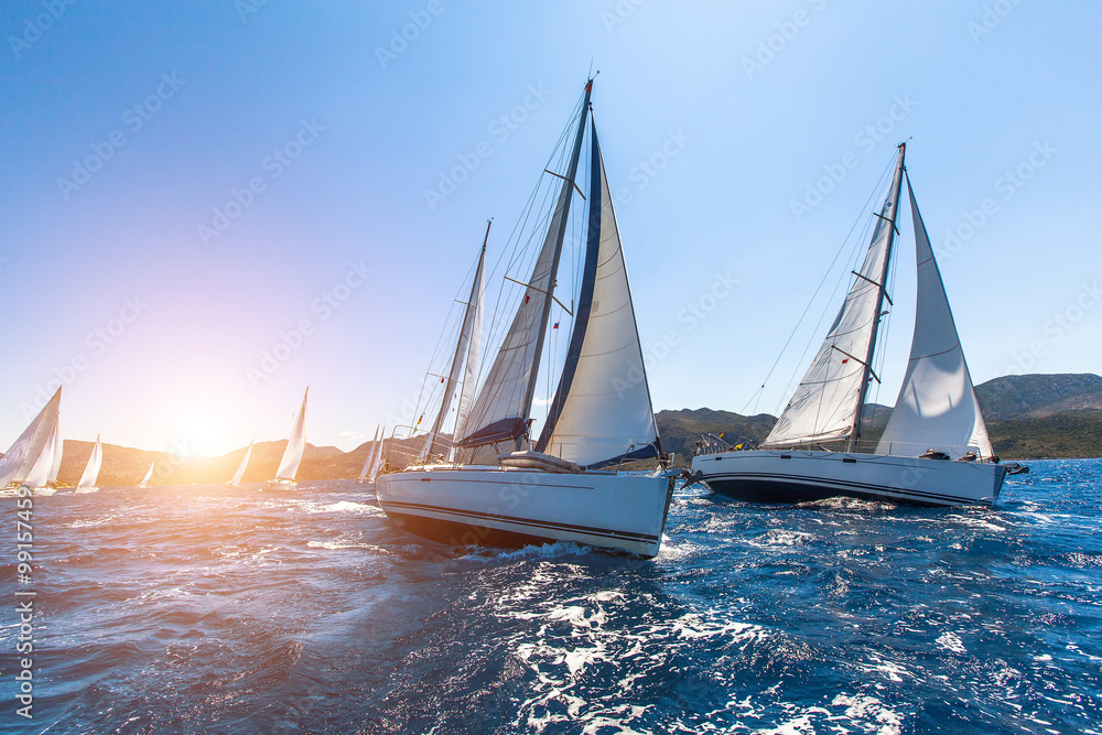 Luxury yachts at Sailing regatta. Sailing in the wind through the waves at the Sea. - obrazy, fototapety, plakaty 