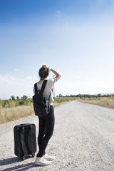 young girl traveling with bag waiting for bus