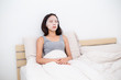 © leungchopan - Woman using facial mask and lying on bed
