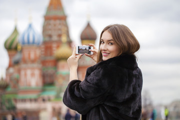 Wall Mural - Young beautiful woman tourist taking pictures on mobile phone