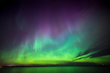 northern lights over lake in finland