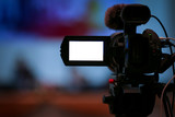 Fototapeta  - video camera in business conference room recording, with a video camera, On a blurred background, white LED display, space for text or pictures.