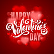 Festive greeting card for Valentines Day with calligraphic text Happy Valentines day on blurred red background with hearts. 