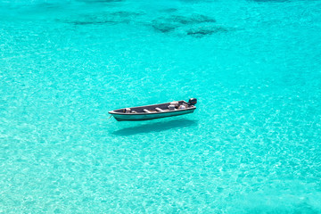 Wall Mural - boat floating on crystal clear water