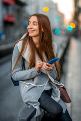 Woman with phone in the city