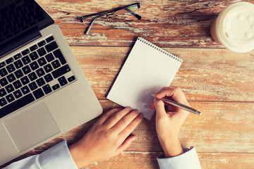 Poster - close up of female hands with laptop and notebook