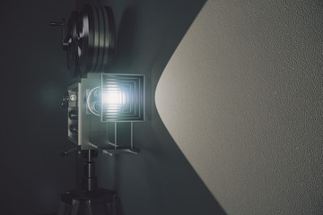 Wall Mural - Old style movie camera at grey wall background