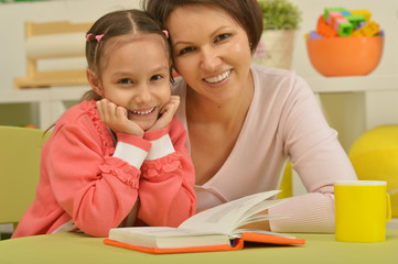 Canvas Print - Daughter and mother reading the book