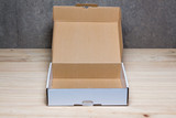 Fototapeta Lawenda - Opened cardboard box on wooden background