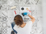 Fototapeta  - Woman paint wall at home.

